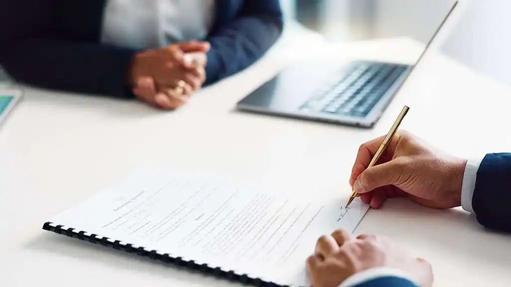 Someone signing a contract