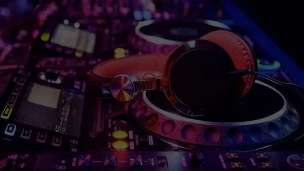 Pair of headphones sitting on some CDJs